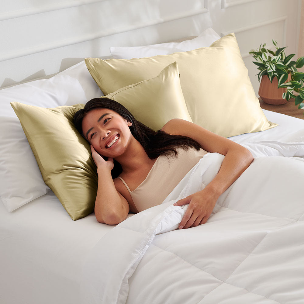 Woman laying on a Champagne silk Pillowcase