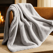 Blanket draped over a chair in front of a fireplace