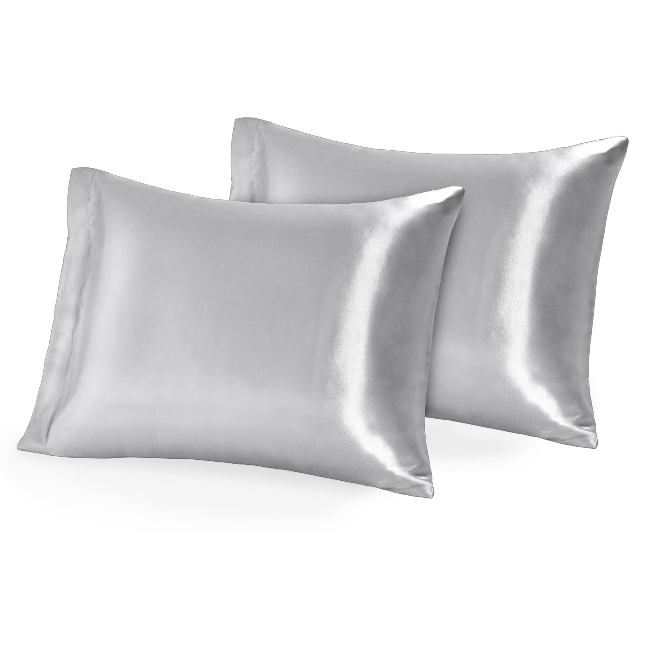 Two pillows topped with silk pillowcases