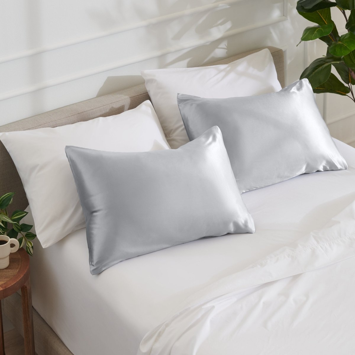 Satin pillowcases on a bed with white bedding