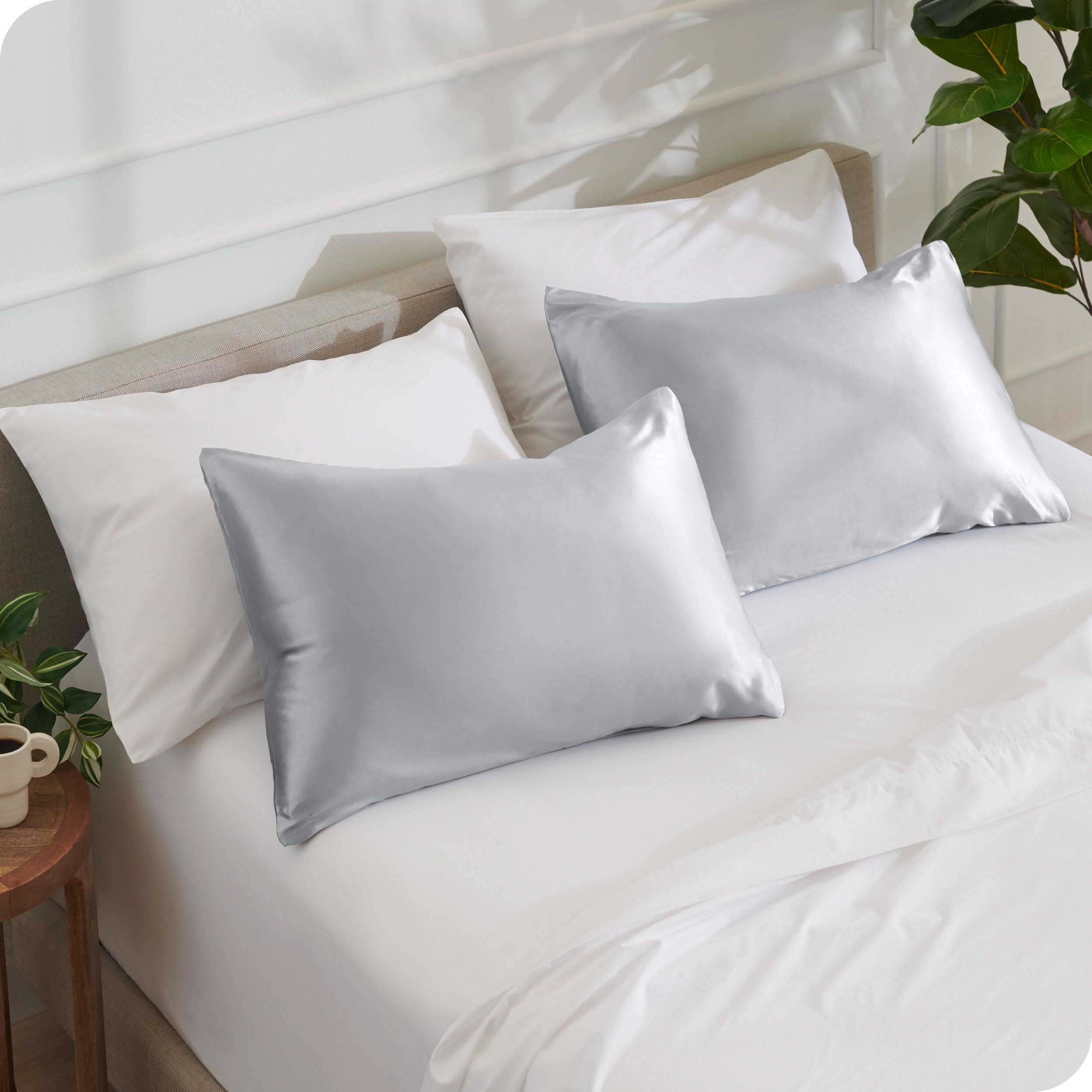 2 satin pillowcases on pillows set on a bed