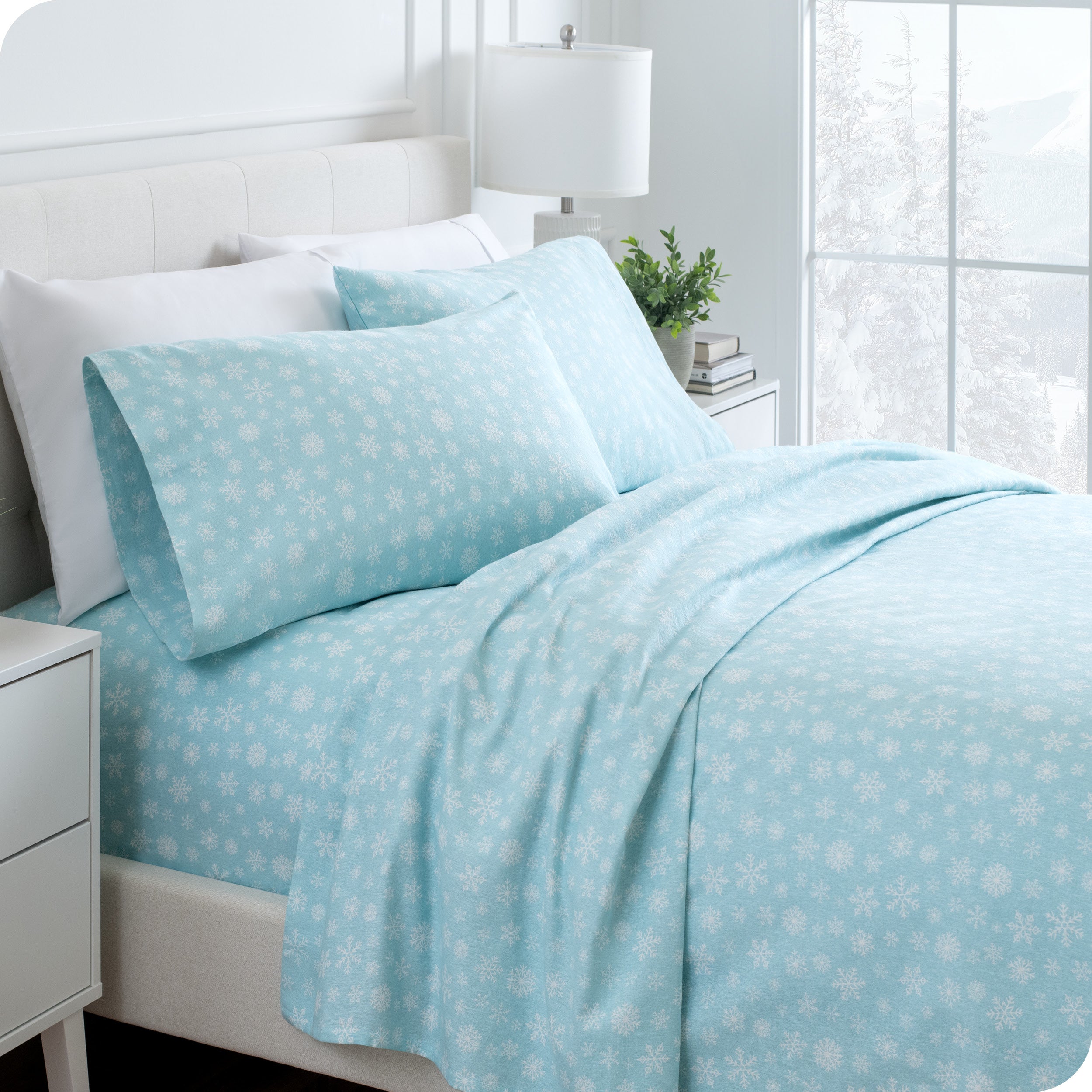 Flannel print sheets neatly spread across a bed