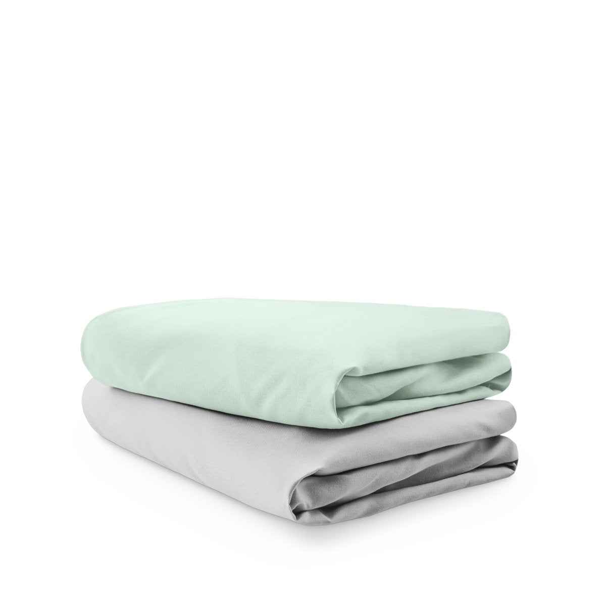 Stack of folded crib sheets on a white background