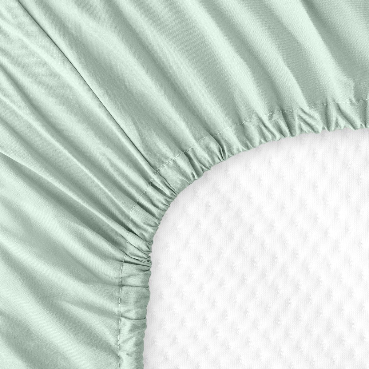 The back of a crib mattress with a fitted sheet on it