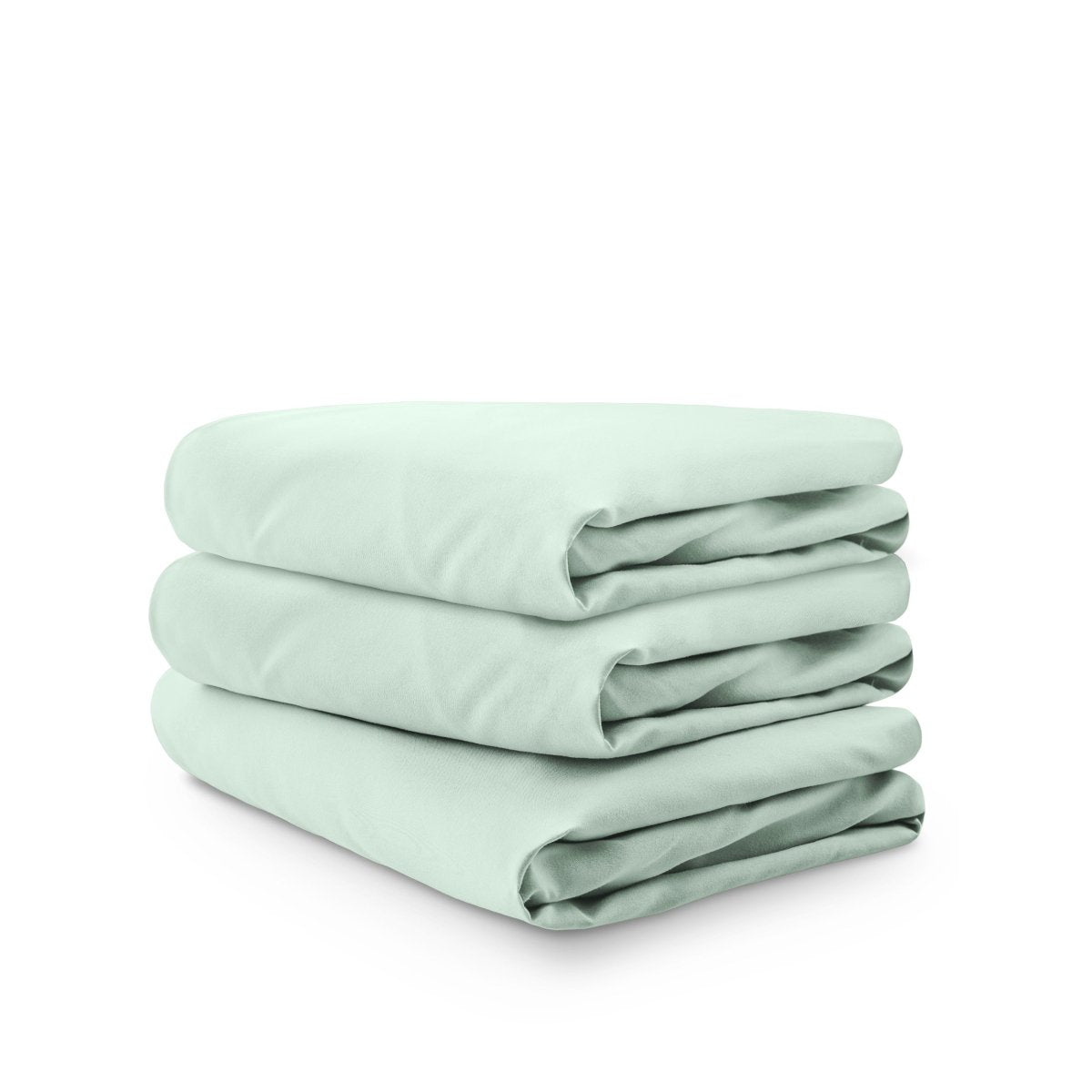 Stack of green folded crib sheets on a white background