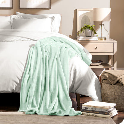 Microplush blanket draped over the corner of a bed