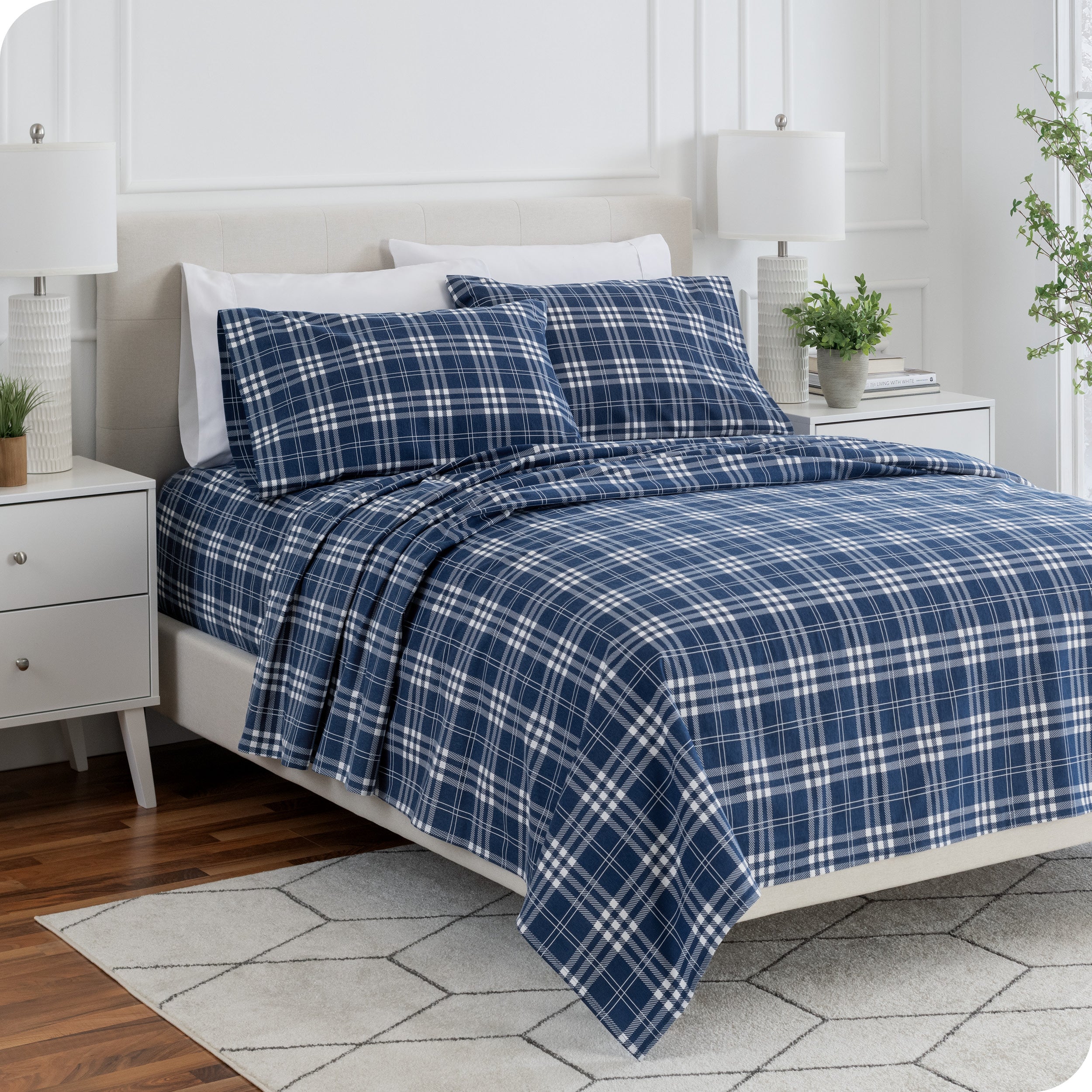 Flannel print sheets neatly spread across a bed