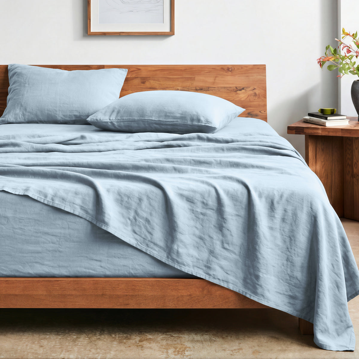 Bed with washed sheets and wooden headboard in a bedroom setting