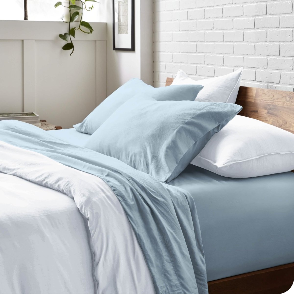 Modern bedroom with washed sheets and duvet cover on a bed
