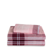 Stack of flannel sheets and pillowcases on a white background