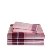 Stack of flannel sheets and pillowcases on a white background