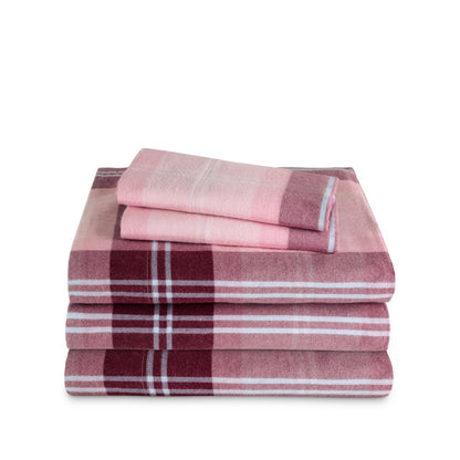 Stack of flannel sheets and pillowcases on a white background