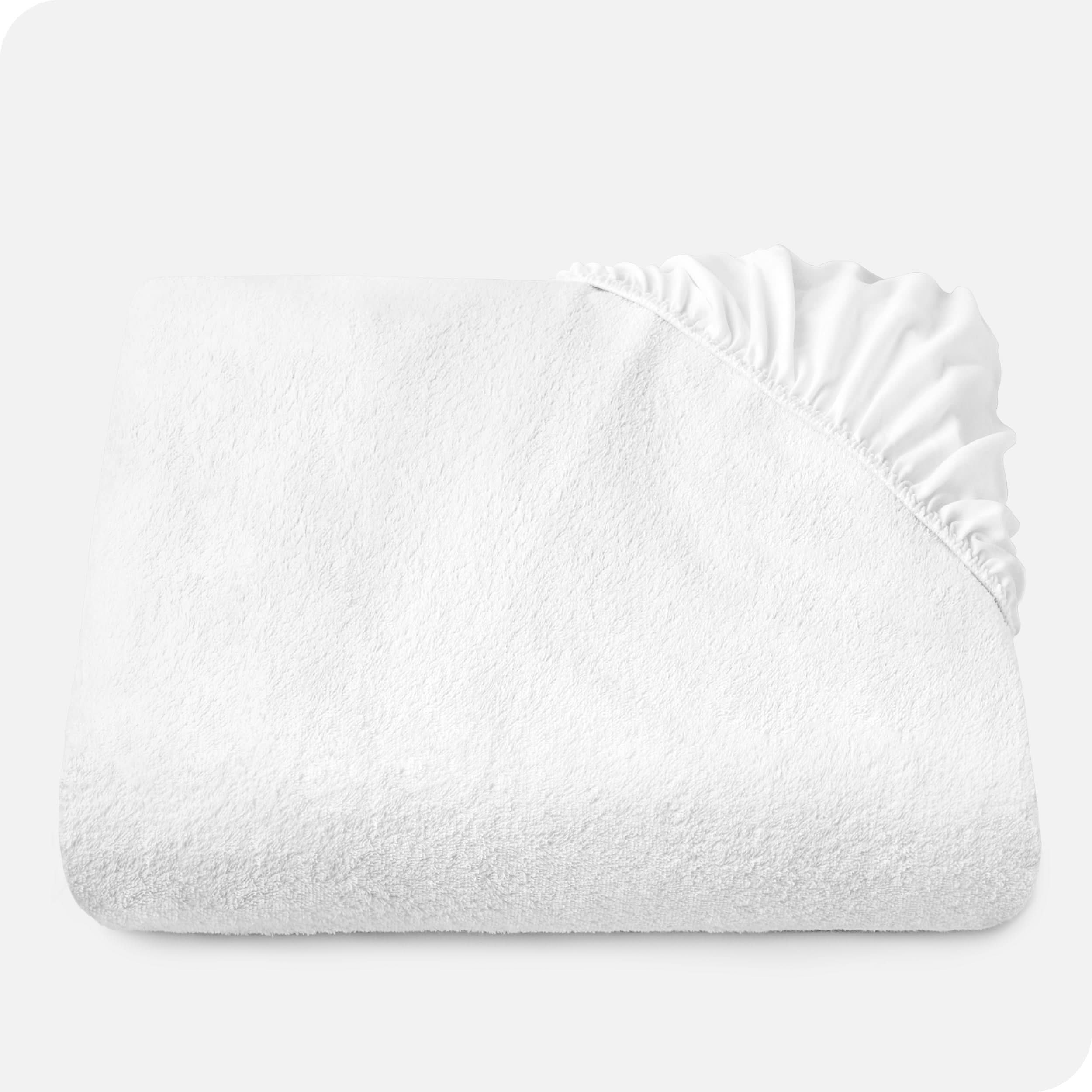 Terry mattress protector folded neatly with the elastic from a corner folded over the top