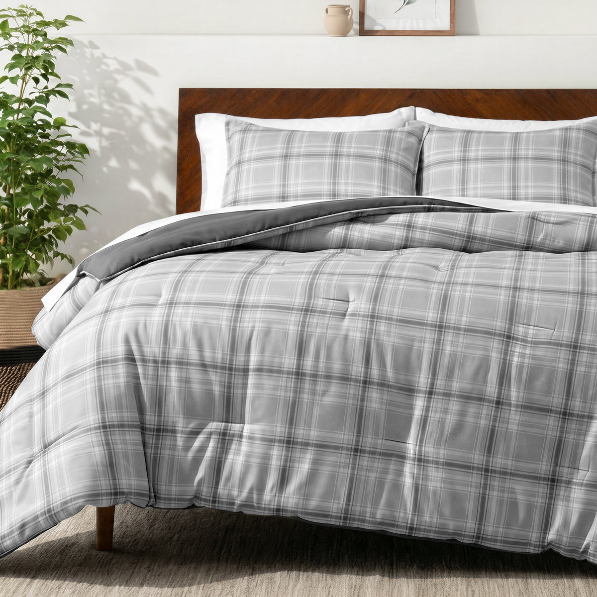 Bedding set on a bed in a bedroom with a side table and lamp.