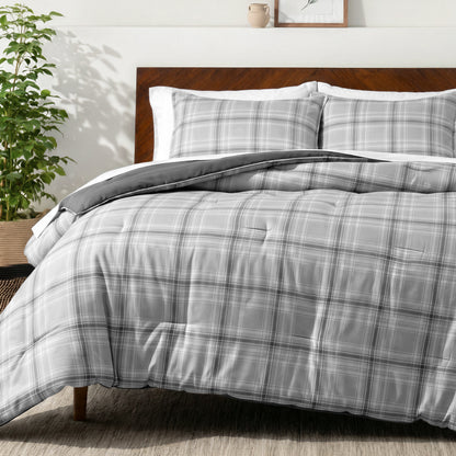 Bedding set on a bed in a bedroom with a side table and lamp.