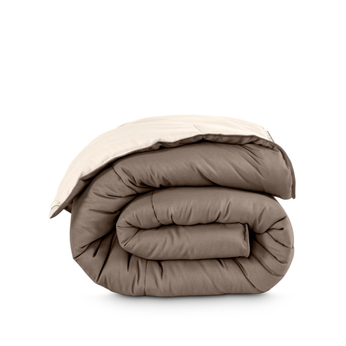 Folded reversible comforter on a white background