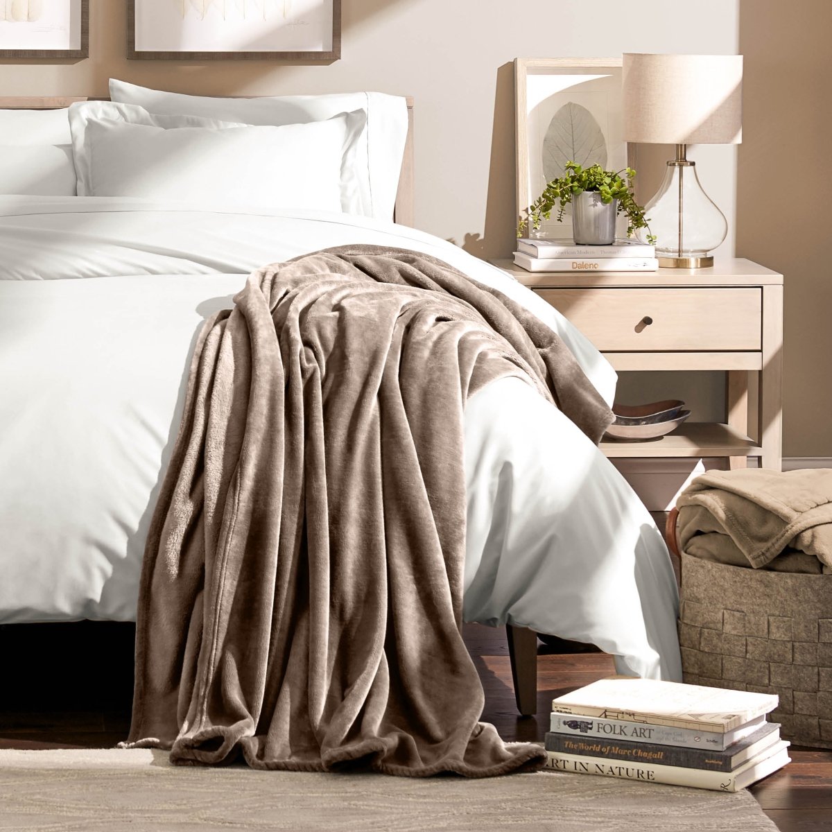 A microplush blanket draped over the corner of a bed