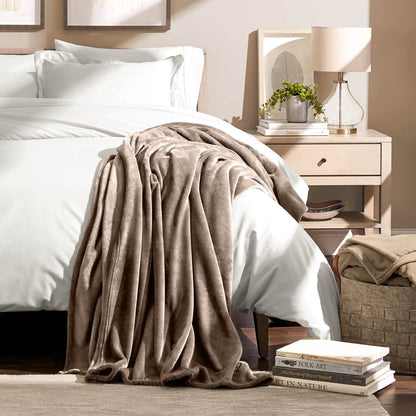 A microplush blanket draped over the corner of a bed