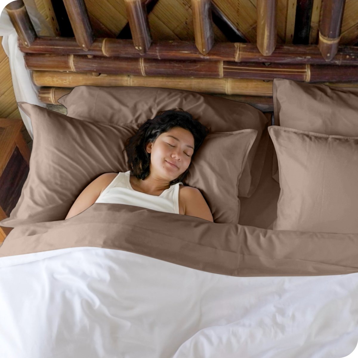 A woman sleeping in a bed made with bamboo sheets