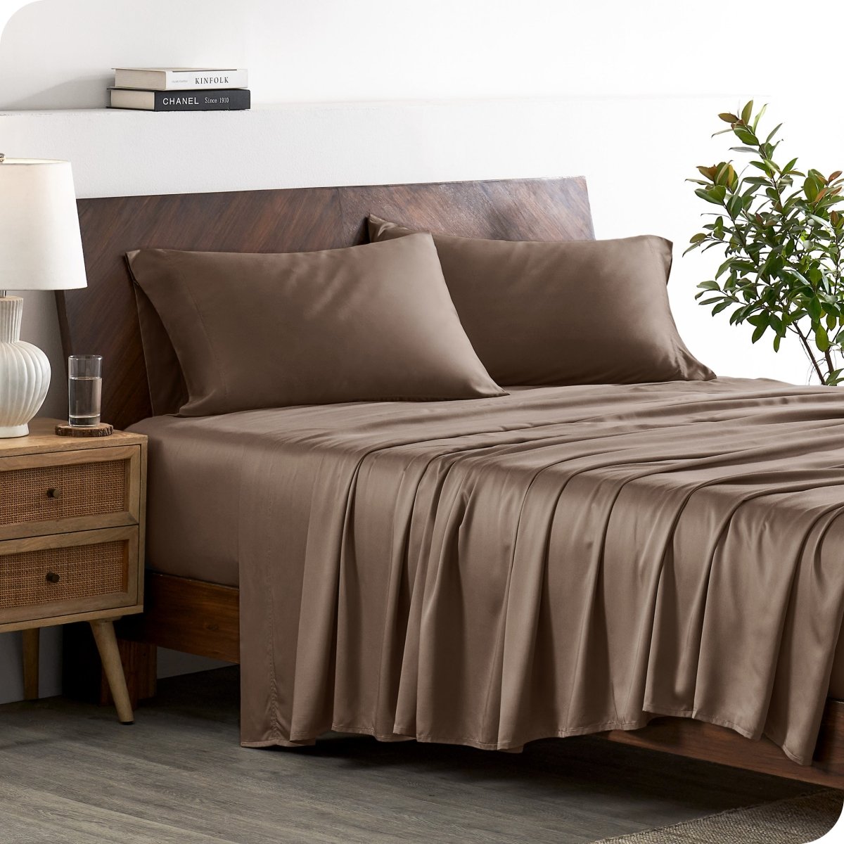A stylish bed with bamboo sheets and pillowcases, showcasing a sophisticated and elegant bedroom setting.