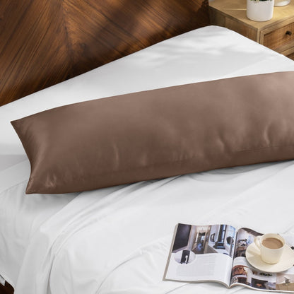 Bamboo pillow on a bed with a magazine and cup of coffee on a wooden nightstand.