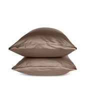 Two taupe pillows stacked on a white background