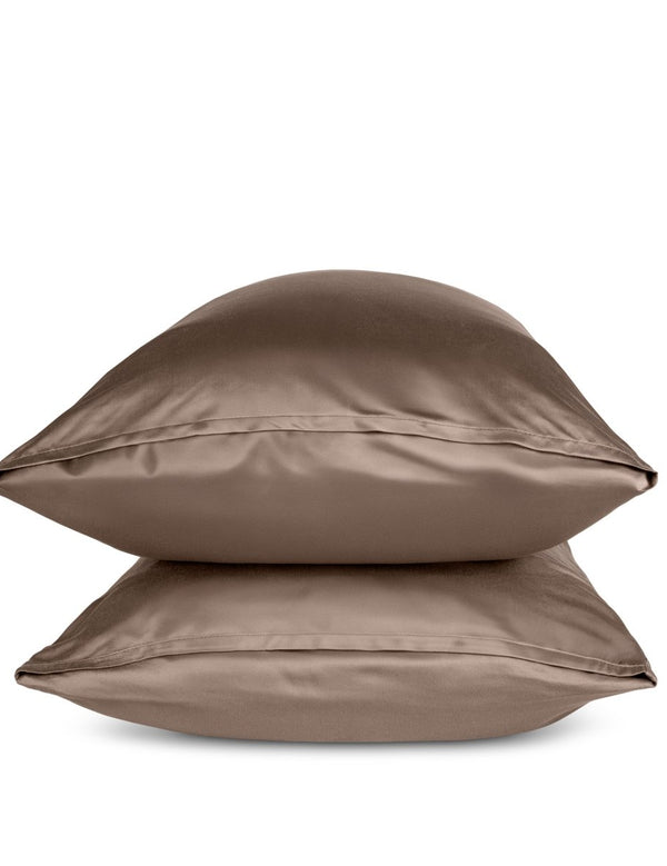 Two taupe pillows stacked on a white background