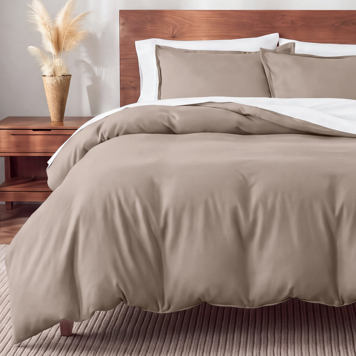 Flannel bedding set on a bed in a bedroom with a nightstand and lamp.