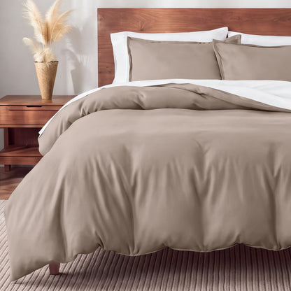 Flannel bedding set on a bed in a bedroom with a nightstand and lamp.
