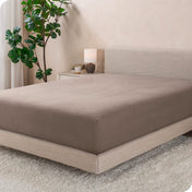 A modern bed with a flannel fitted sheet on