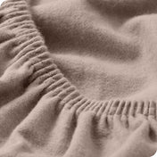 Close up of the elastic portion of a flannel fitted sheet