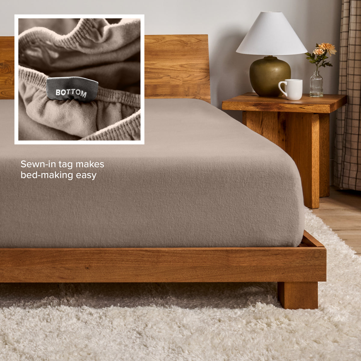 A flannel fitted sheet on a mattress with a wooden bed frame