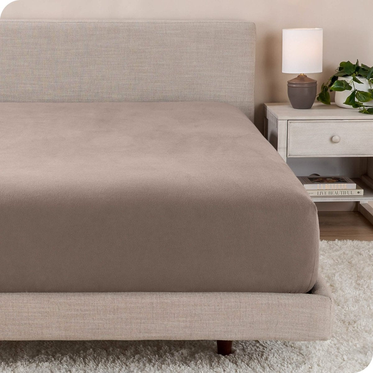 A close up of a modern bed with a flannel fitted sheet on
