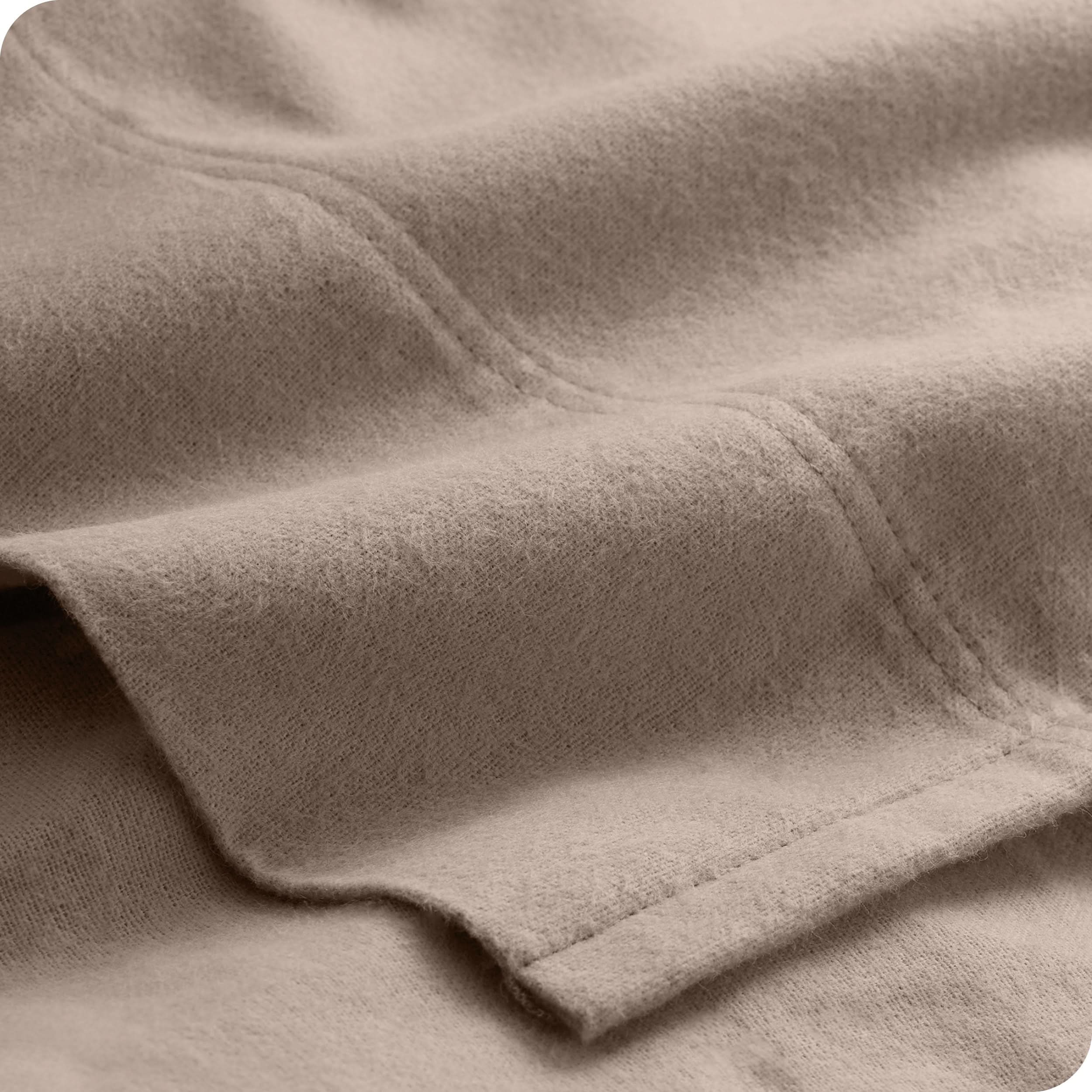 A close view of the flat top sheet showing the texture and stitching