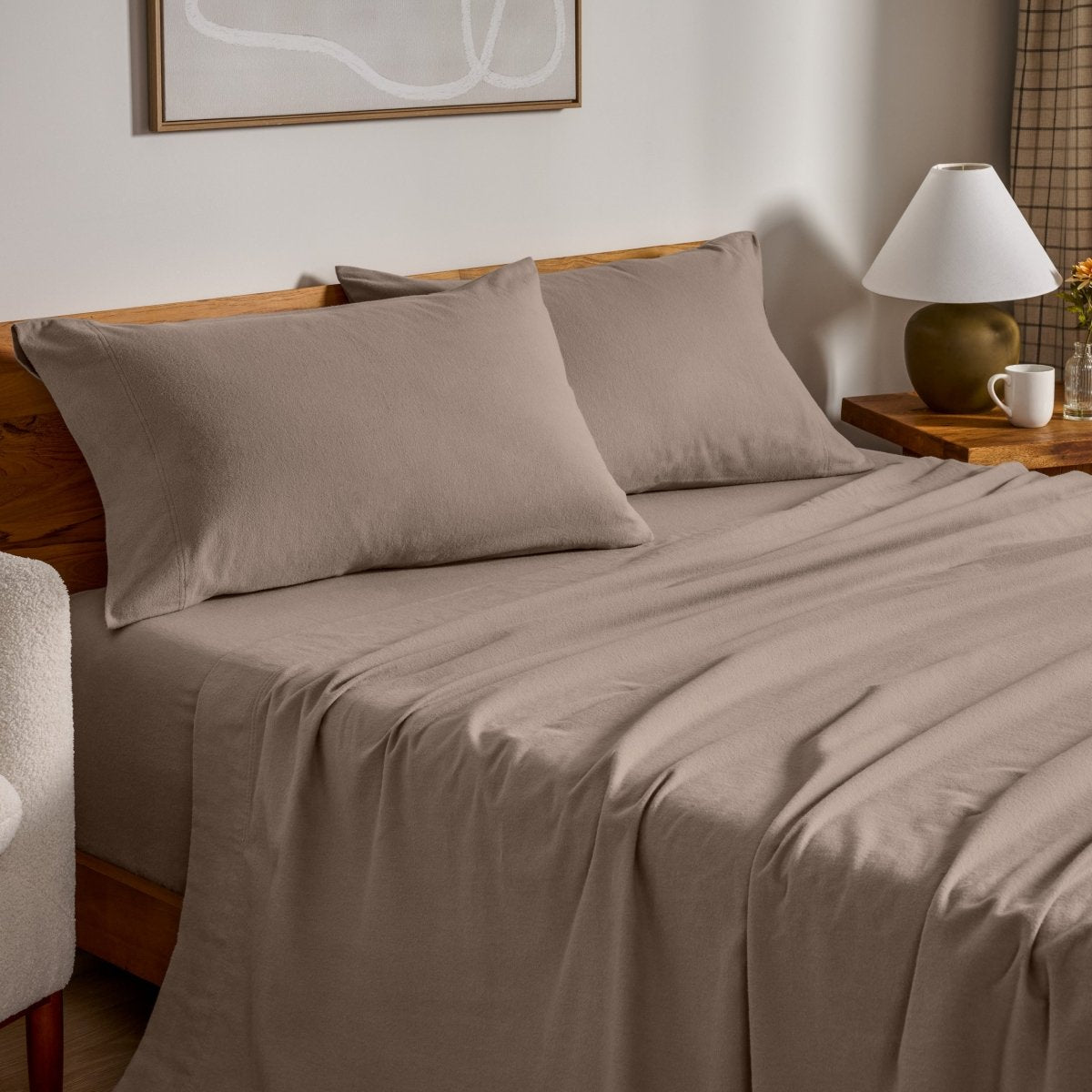Flannel bed sheets and pillowcases on a bed in a bedroom setting.