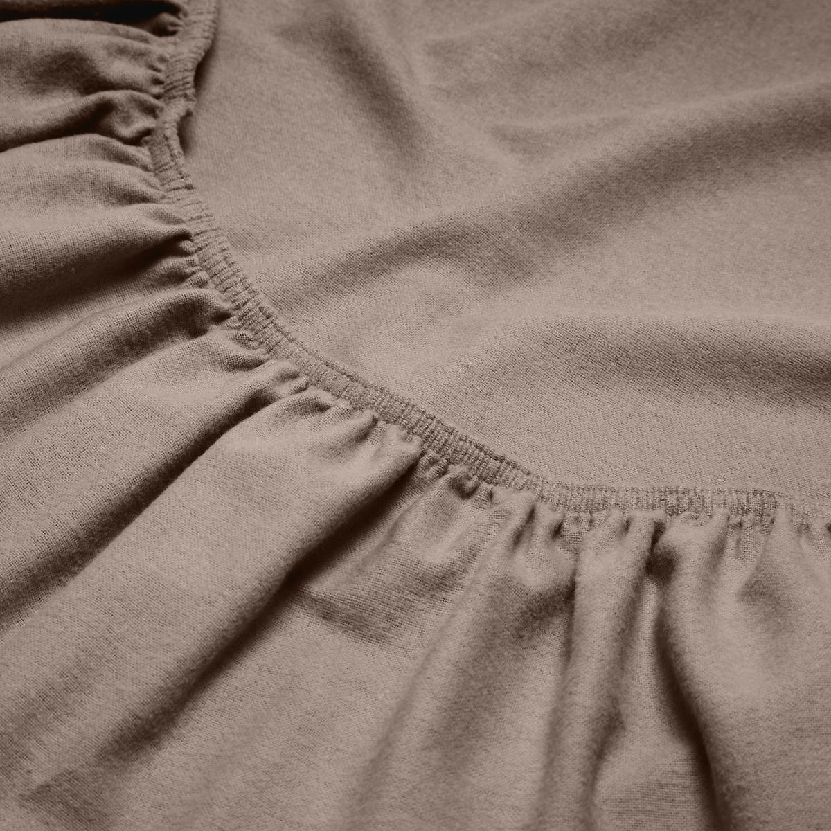 Close-up of a flannel fitted sheet with gathered elastic