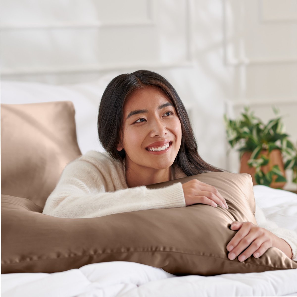 Woman lying on abed with a silk pillowcase
