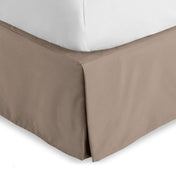 Bed skirt on a bed with white bedding