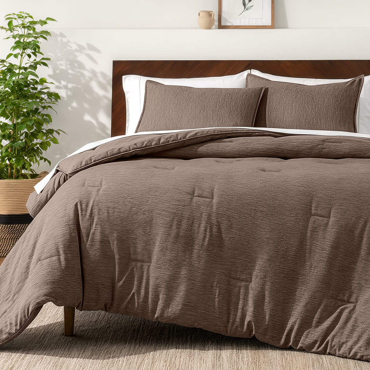 Bedding set on a bed in a bedroom with a side table and lamp.