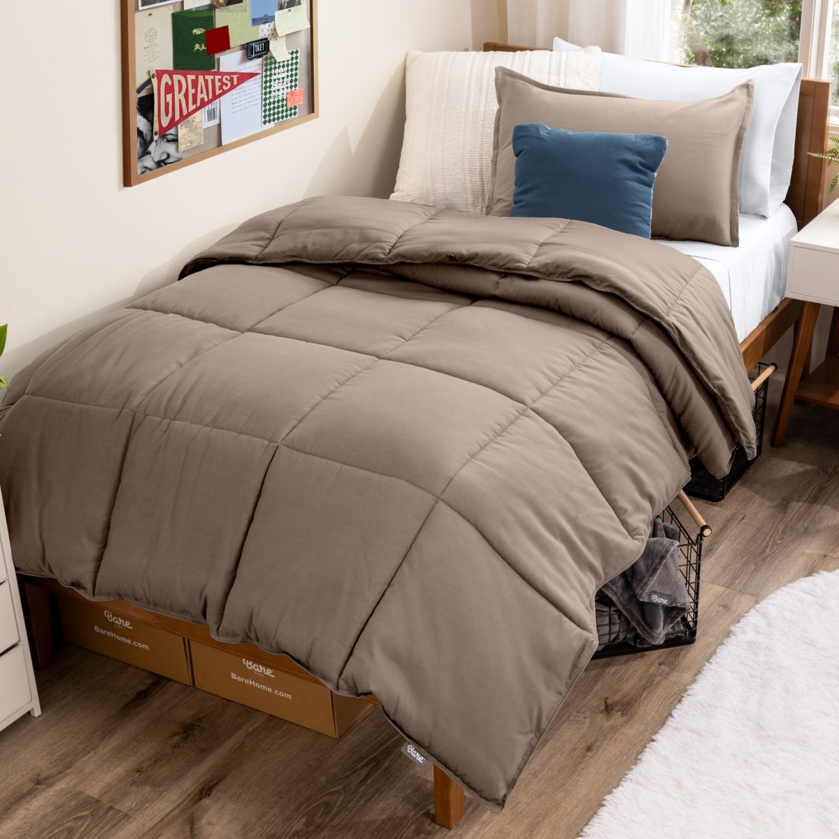 Bed with comforter and pillows in a dorm room