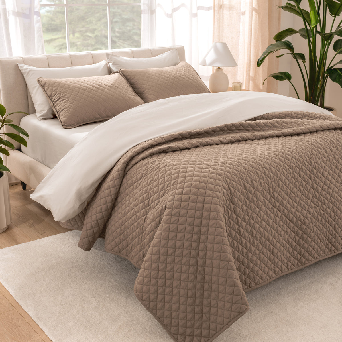 Bedroom showing coverlet set laying on the bed with the quilt folded over on itself