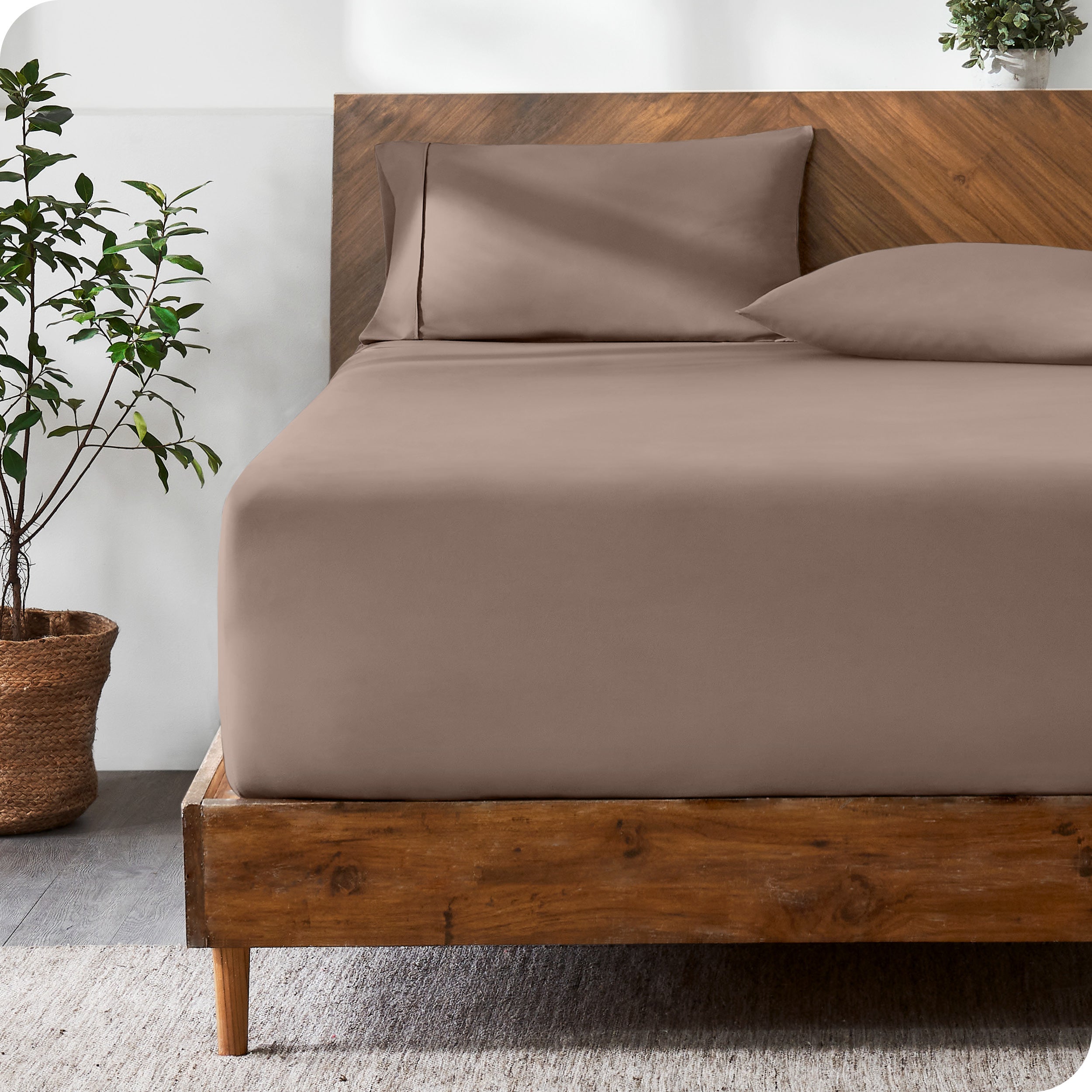 Wooden bed with ultra soft bedding in a minimalistic room.