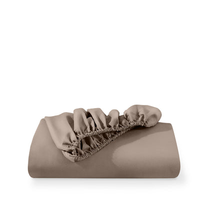 A deep pocket fitted sheet folded on a white background
