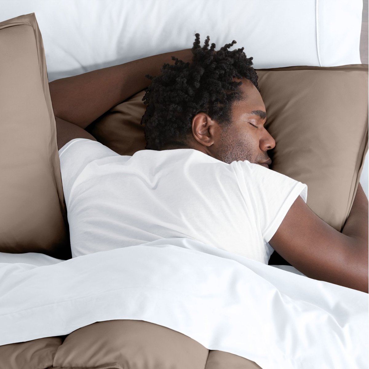 Man sleeping with his head resting on a pillow sham