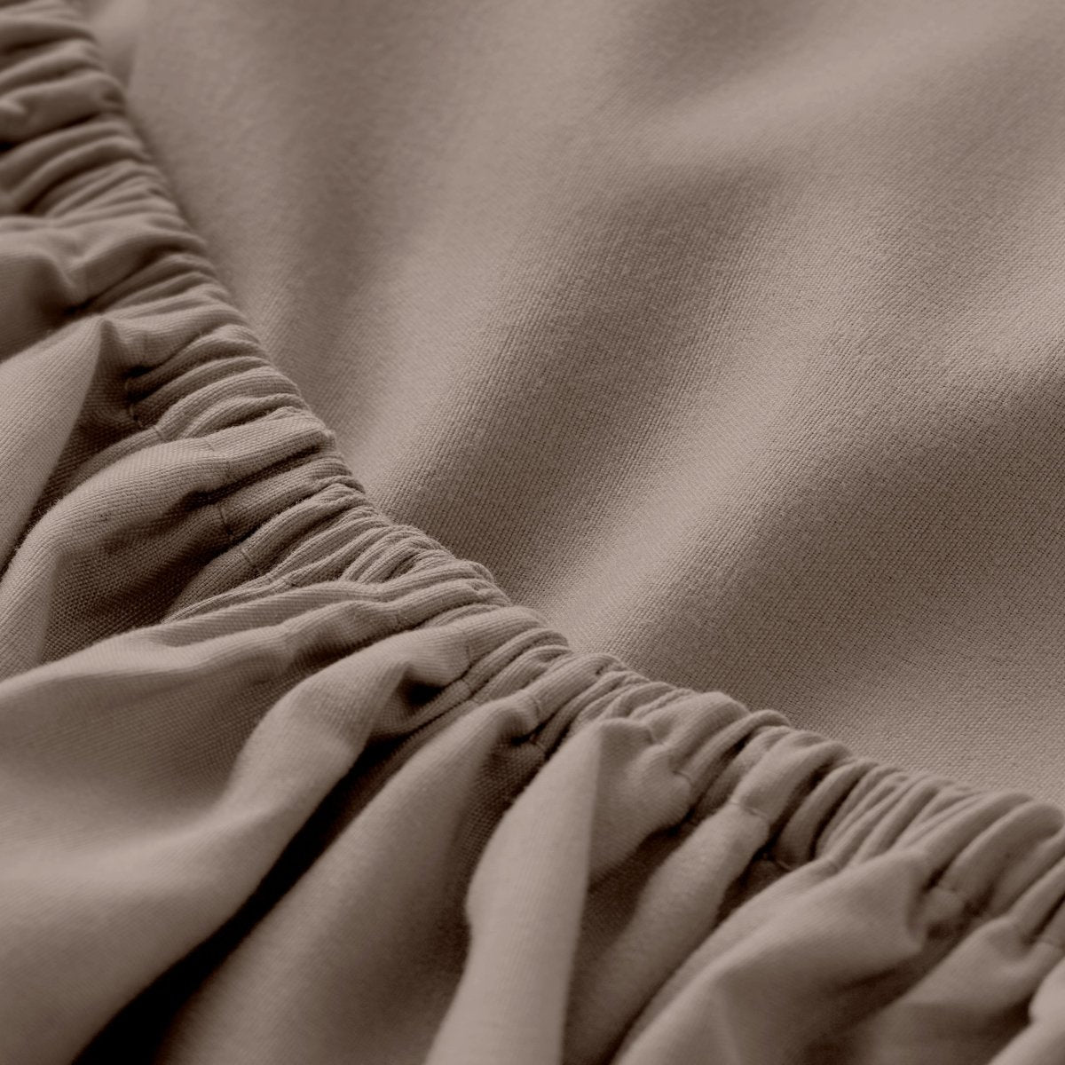 A close-up of a fitted sheet with elasticized edge.