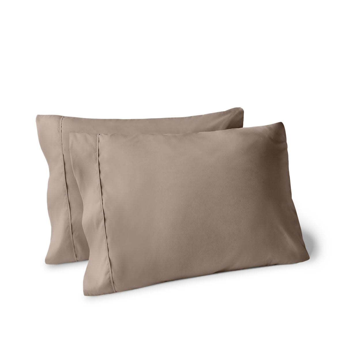 Two pillows on a white background with pillowcases on them