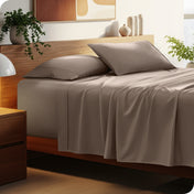 Bed with microfiber bedding and wooden headboard in a bedroom setting
