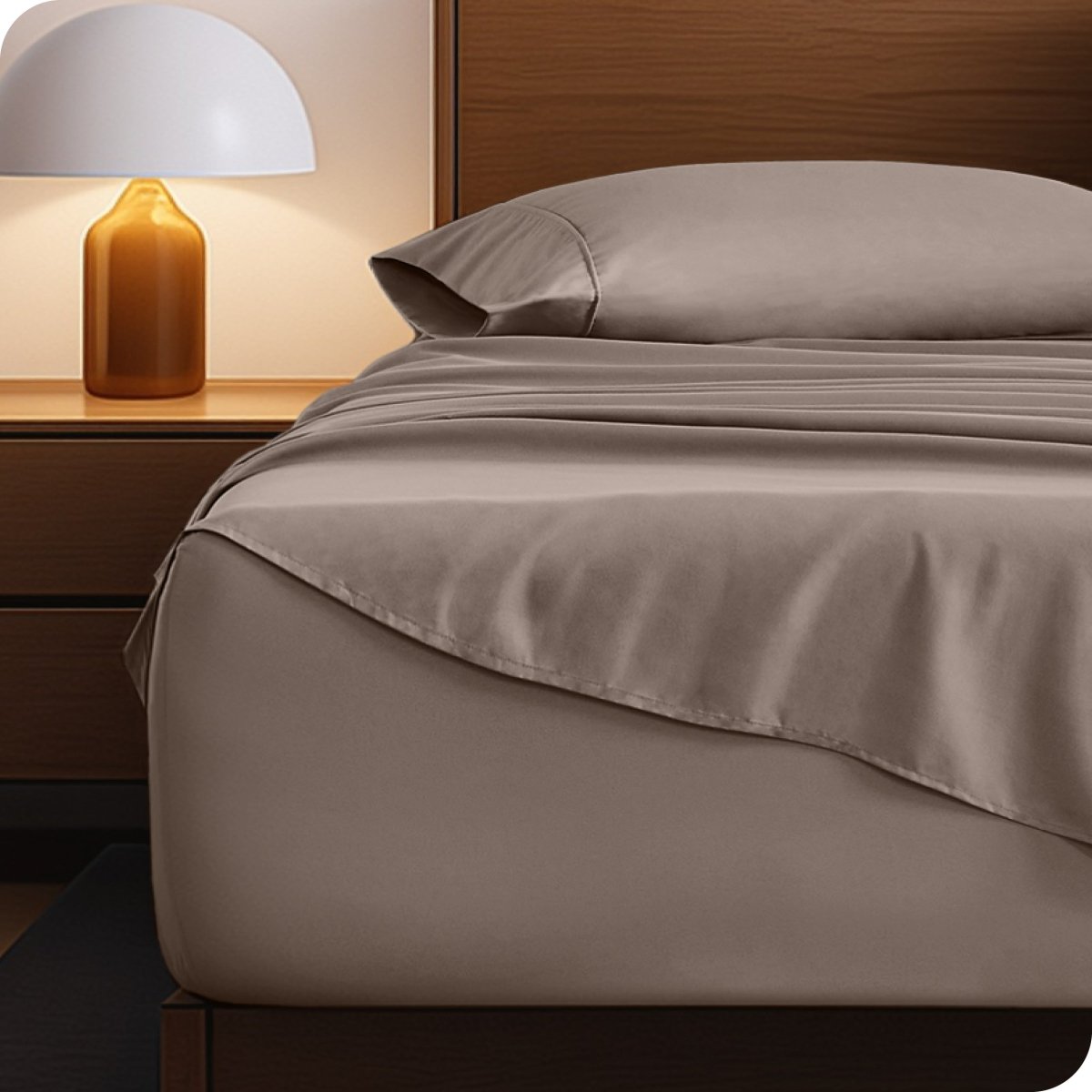 Microfiber bed sheets on a neatly made bed with a wooden headboard and nightstand.