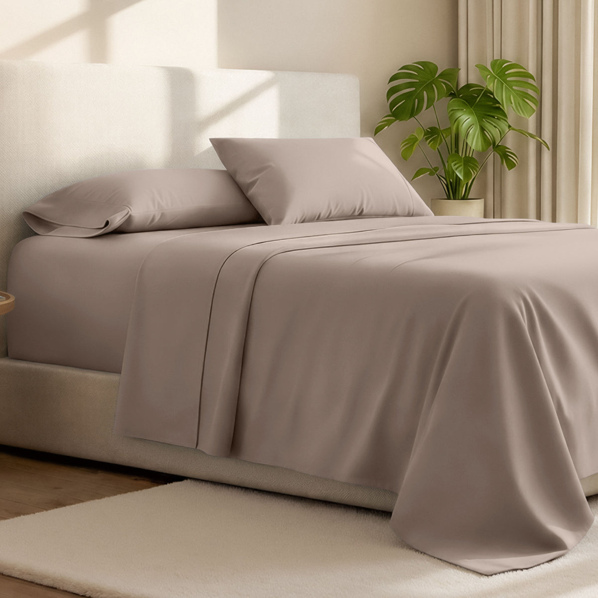 Microfiber bed sheets on a neatly made bed with a wooden headboard and nightstand.