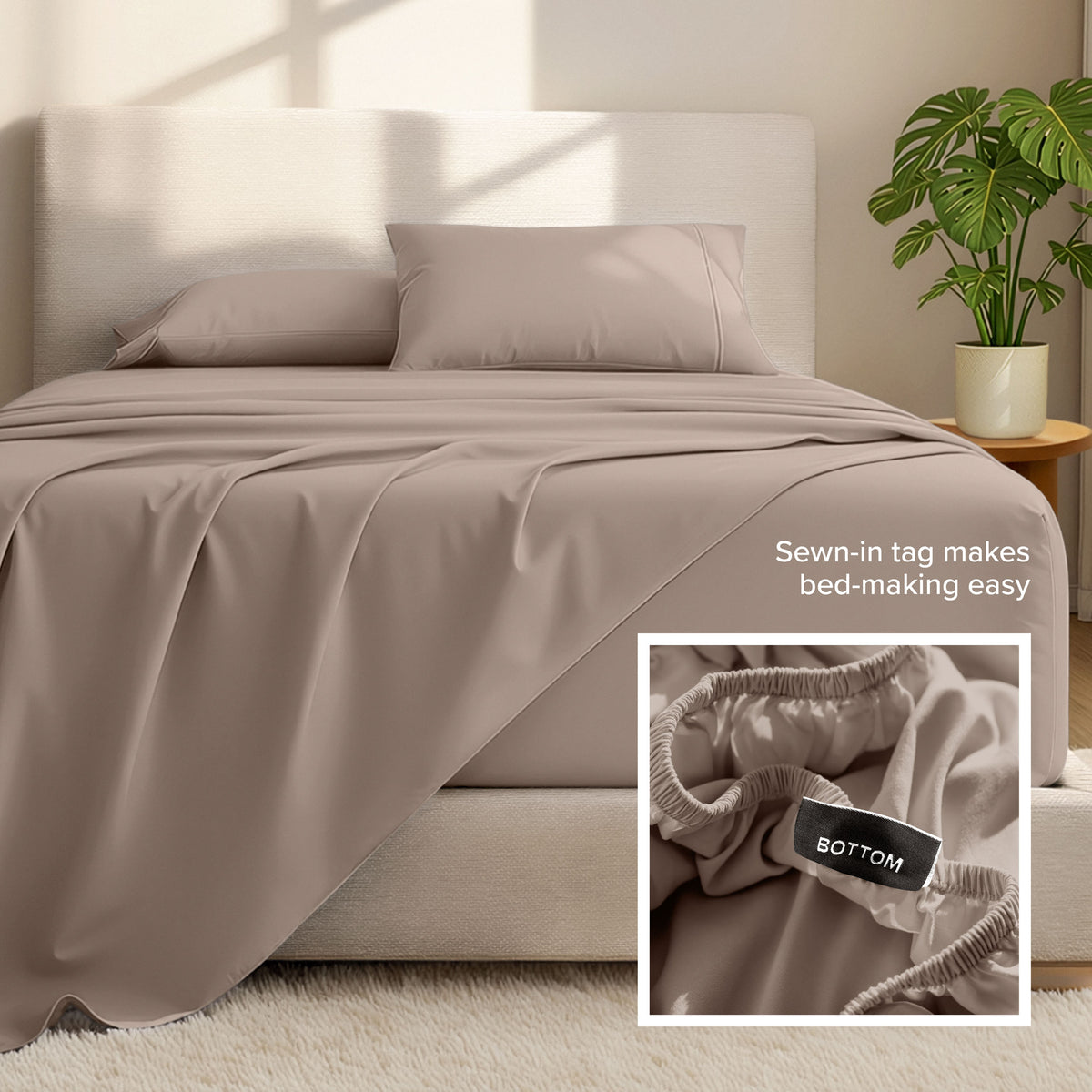 Bed sheets and pillows on a bed with a plant in the background